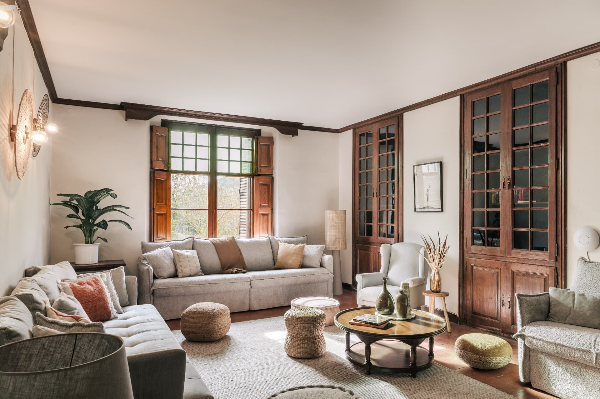 Light-filled sitting room with linen sofas and timber cabinetry