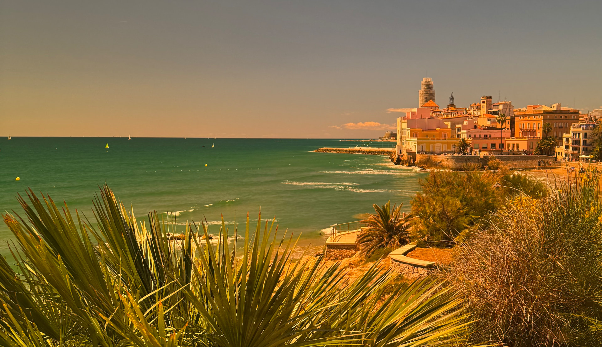 Mediterranean coastline at golden hour with a hillside town