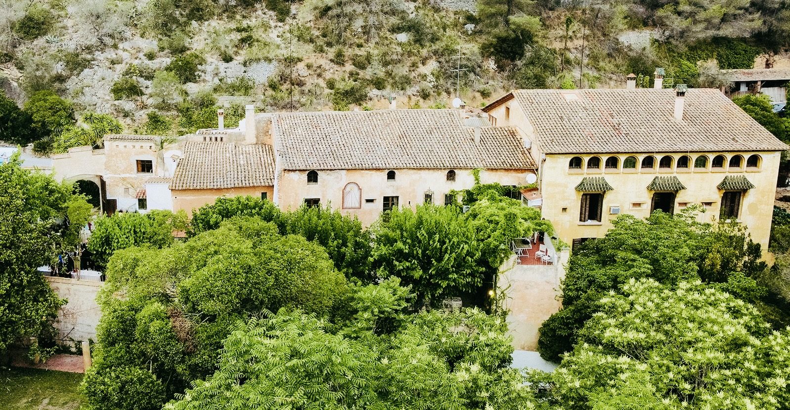 Catalan masia surrounded by gardens and forest